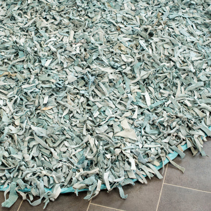 Tapis décoratif moderne SAFAVIEH en cuir shaggy fait main Doinita