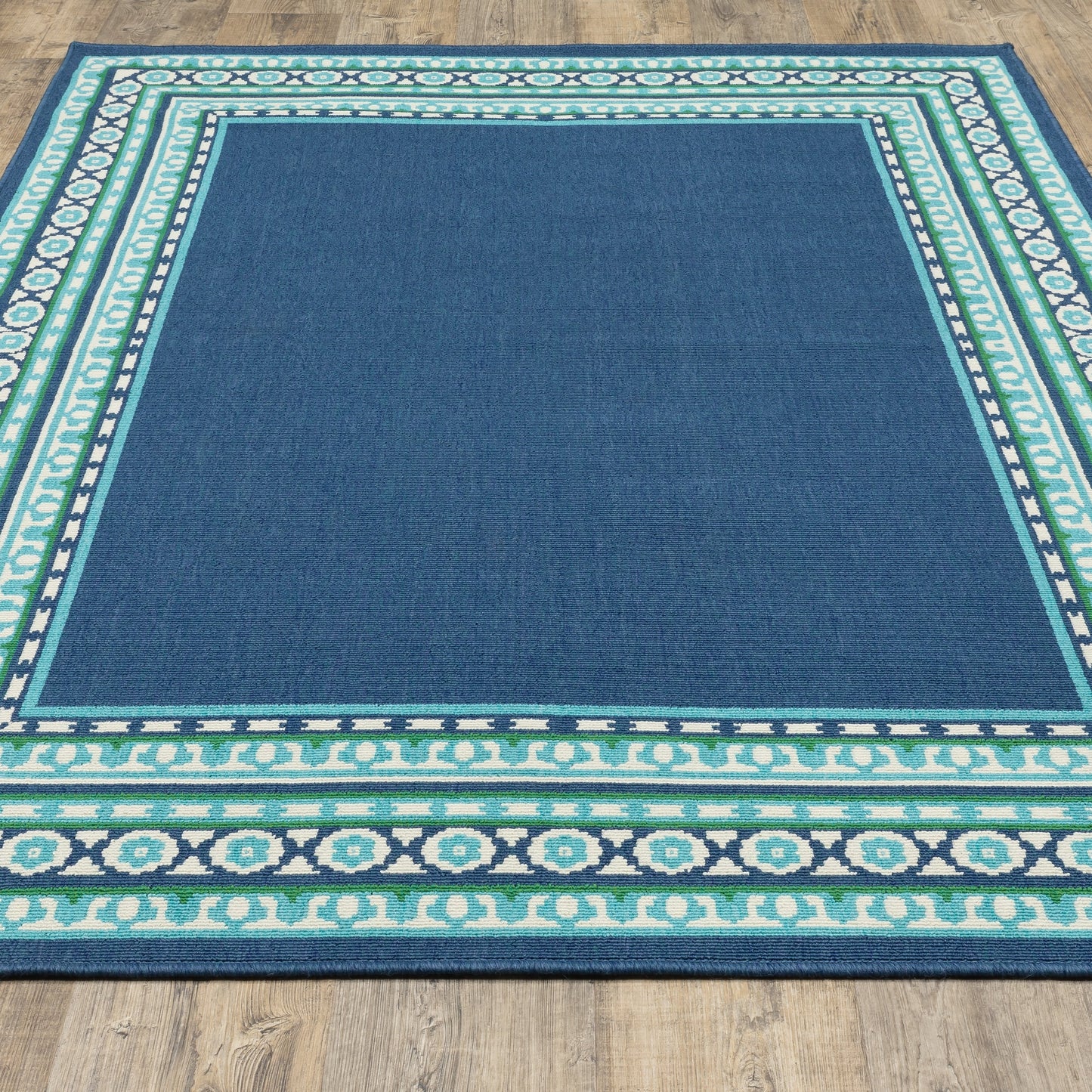 Tapis d'intérieur/extérieur Style Haven Martinque à bordure verte bleu marine ~